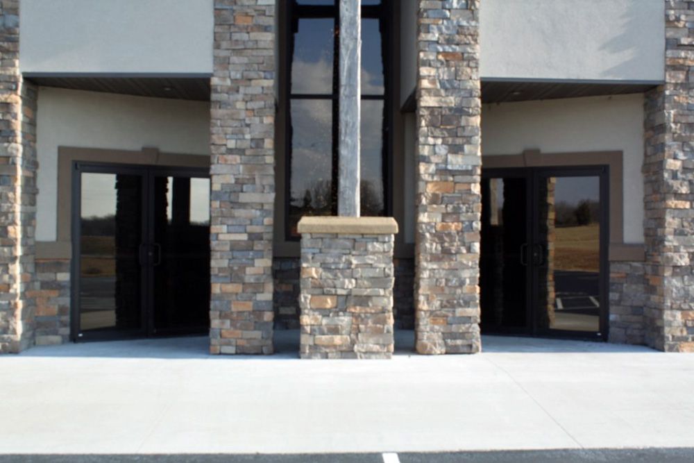 A brick building with a cross in front of it