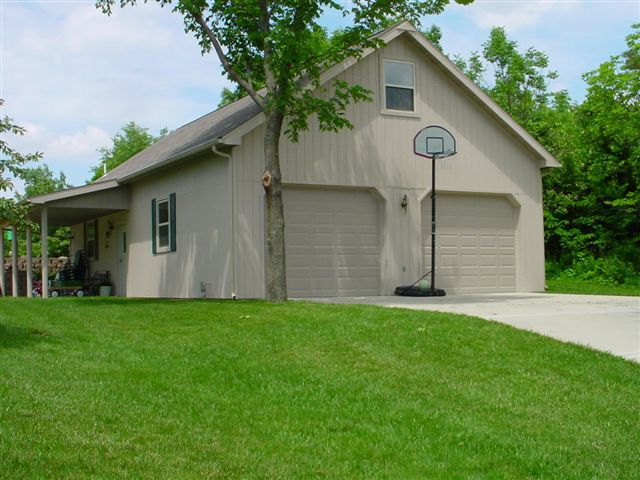 A garage with a basketball hoop in front of it